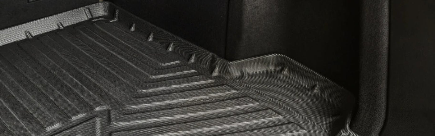 Durable black boot liner with raised edges, designed for spill and dirt protection in vehicle cargo area.